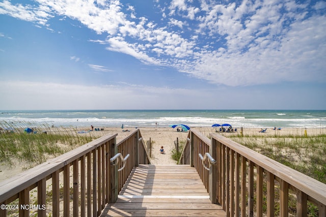 view of home's community featuring a beach view and a water view