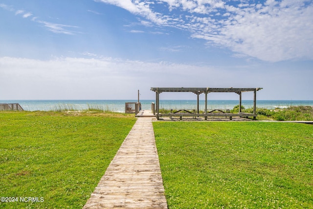 dock area with a yard and a water view