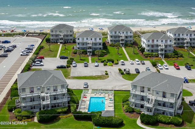 birds eye view of property featuring a beach view and a water view