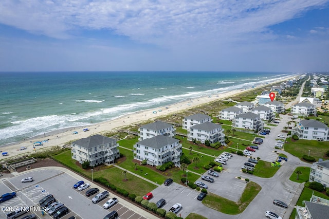 bird's eye view with a water view and a beach view