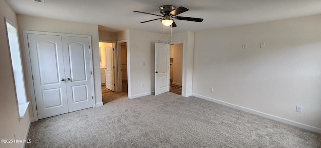 unfurnished bedroom with ceiling fan, ensuite bath, a closet, and light carpet