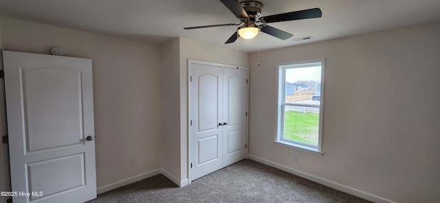 unfurnished bedroom with ceiling fan, light colored carpet, and a closet