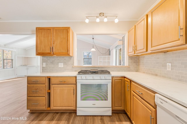 kitchen with white appliances, tasteful backsplash, vaulted ceiling, and light hardwood / wood-style flooring