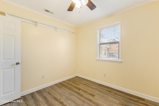 empty room with wood-type flooring, ceiling fan, and crown molding