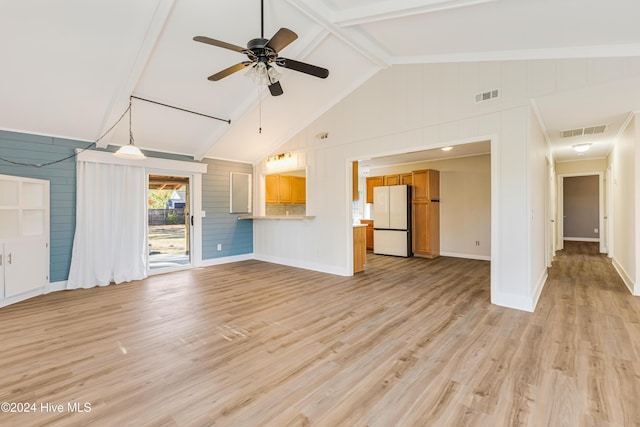 unfurnished living room with wood walls, high vaulted ceiling, light hardwood / wood-style flooring, ceiling fan, and beam ceiling