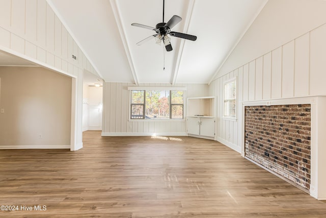 unfurnished living room with lofted ceiling with beams, light hardwood / wood-style floors, and ceiling fan