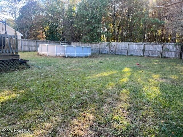 view of yard with a pool side deck