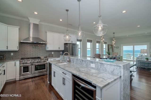 kitchen featuring wine cooler, a water view, wall chimney range hood, and premium appliances