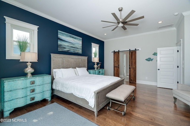 bedroom with crown molding, dark wood-type flooring, a barn door, and ceiling fan