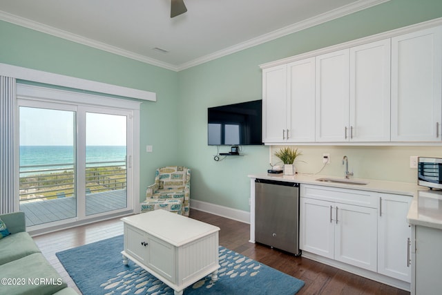 interior space with sink, a water view, white cabinetry, crown molding, and appliances with stainless steel finishes