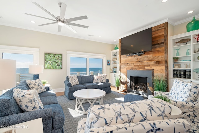 living room featuring hardwood / wood-style floors, ornamental molding, and ceiling fan