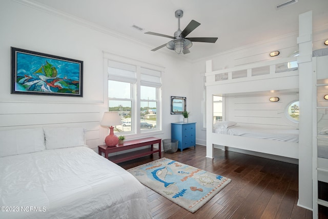 bedroom with ceiling fan, ornamental molding, and dark hardwood / wood-style flooring