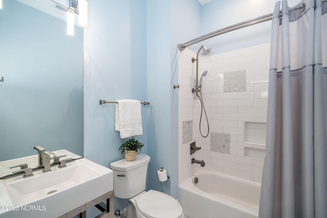 full bathroom featuring sink, shower / bath combination with curtain, and toilet