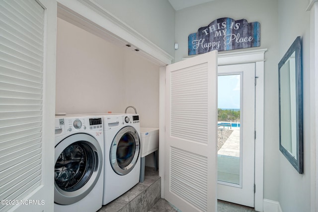 clothes washing area featuring separate washer and dryer