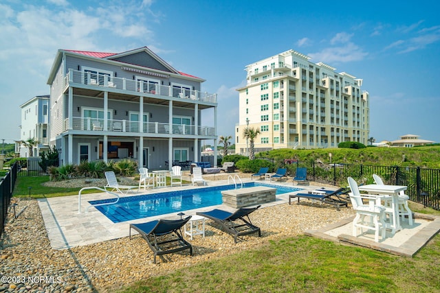 view of pool featuring a hot tub and a patio