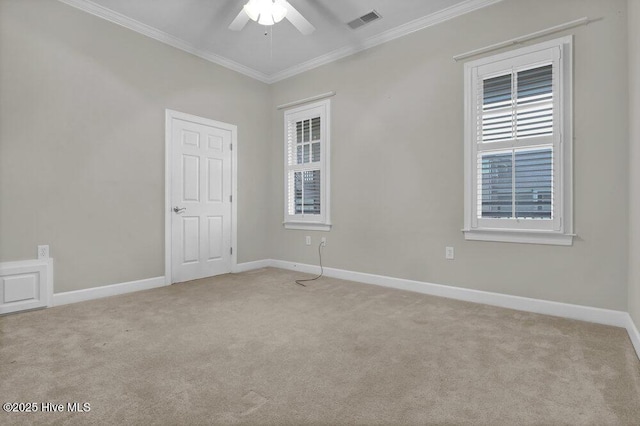 empty room with light carpet, ornamental molding, visible vents, and baseboards