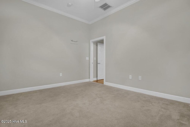 unfurnished room featuring baseboards, visible vents, ornamental molding, and light colored carpet