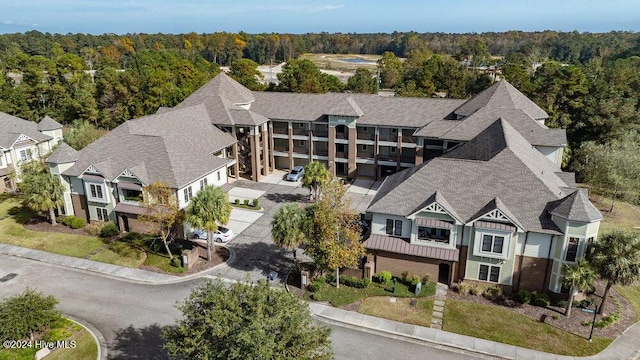 birds eye view of property with a wooded view and a residential view