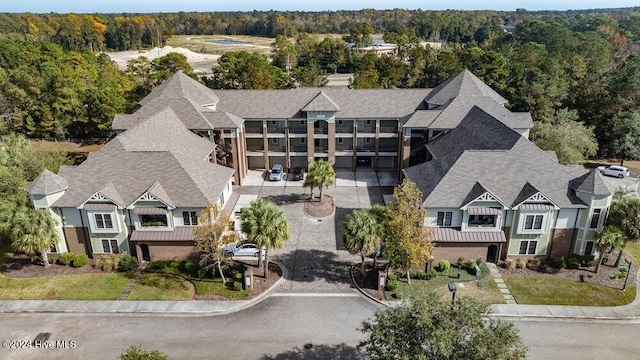 drone / aerial view with a wooded view