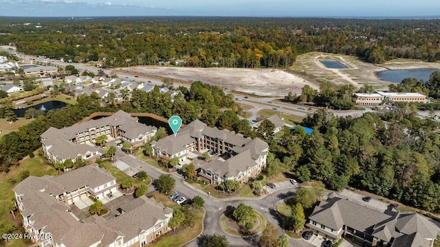 drone / aerial view featuring a residential view and a forest view