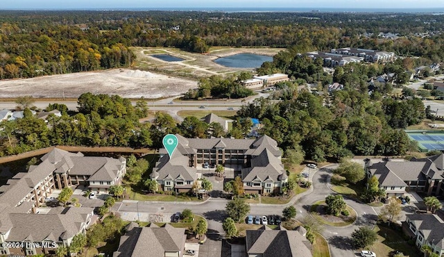 birds eye view of property with a residential view and a view of trees