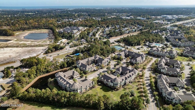 bird's eye view with a water view, a residential view, and a view of trees