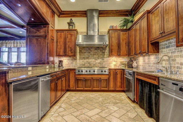 kitchen with ornamental molding, a sink, stainless steel appliances, wall chimney range hood, and backsplash