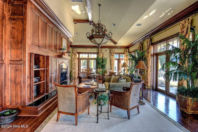 living room with crown molding, visible vents, hardwood / wood-style floors, and french doors