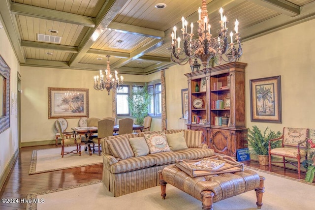 living area with hardwood / wood-style flooring, beam ceiling, baseboards, and a notable chandelier