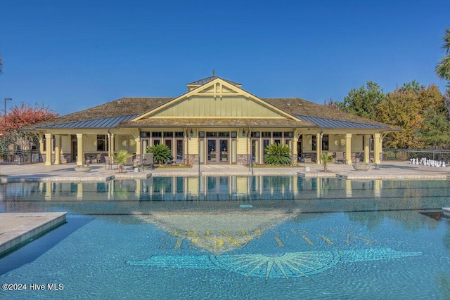 pool with a patio area and fence