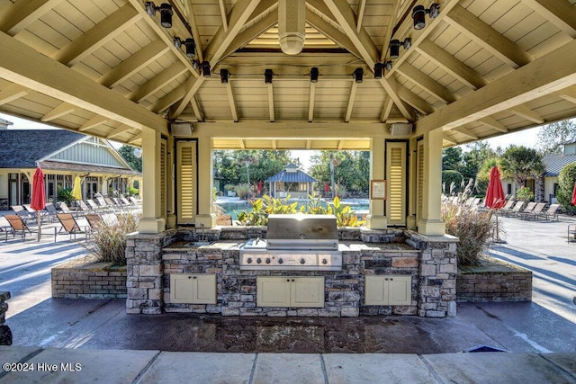 view of patio with area for grilling, a gazebo, and an outdoor kitchen