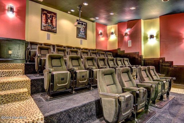 carpeted home theater featuring recessed lighting and a wainscoted wall