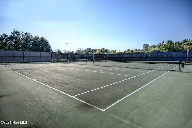 view of tennis court with fence