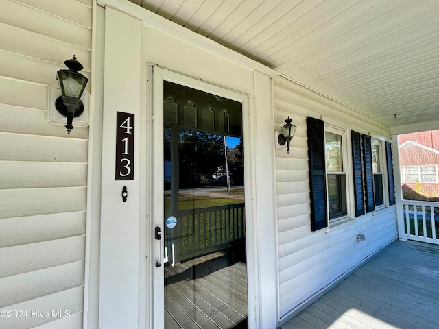 view of exterior entry featuring a porch