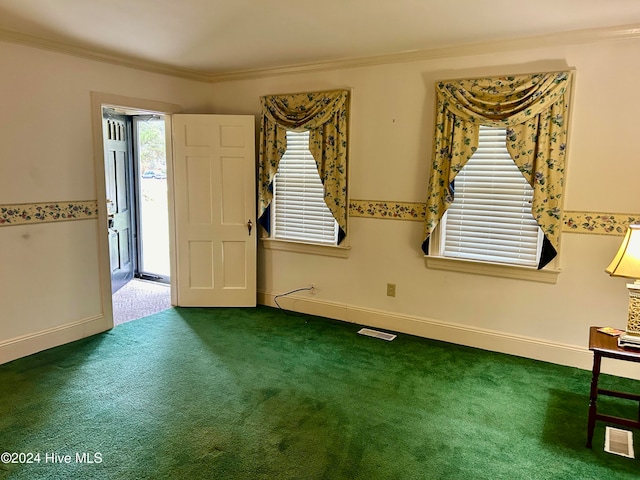 empty room featuring carpet and crown molding