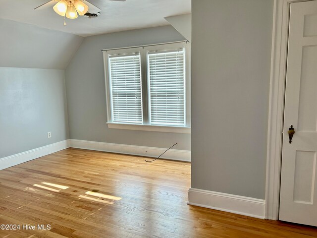 bonus room with light hardwood / wood-style floors, lofted ceiling, and ceiling fan