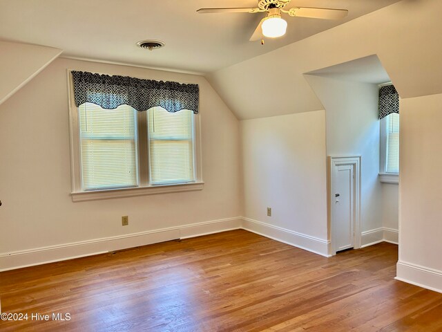 bonus room with a wealth of natural light, lofted ceiling, light hardwood / wood-style floors, and ceiling fan