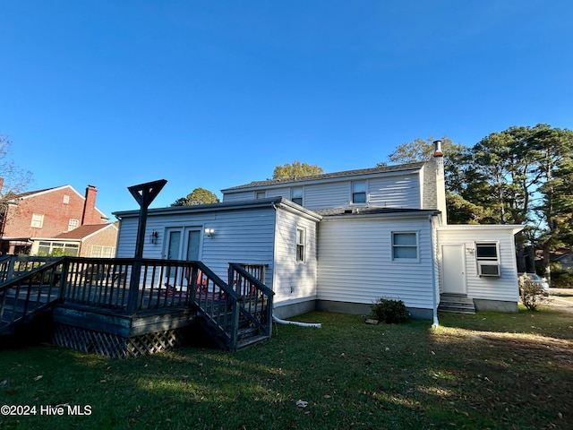 rear view of property with cooling unit, a yard, and a deck