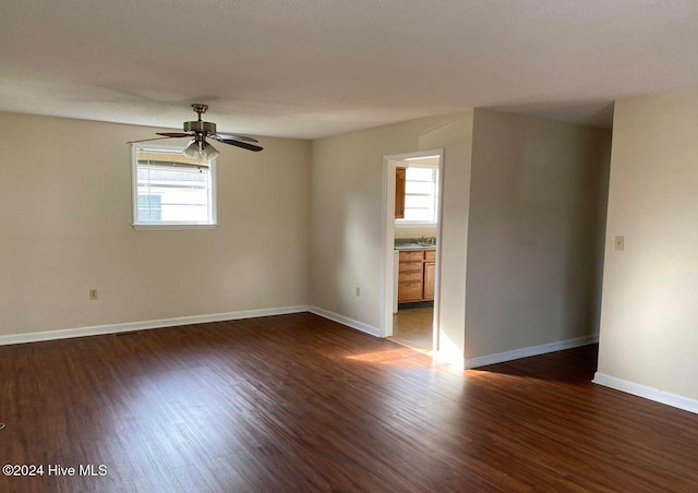 empty room featuring sink, dark hardwood / wood-style floors, and ceiling fan