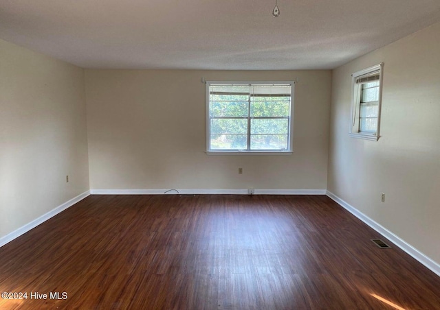 spare room featuring dark hardwood / wood-style flooring