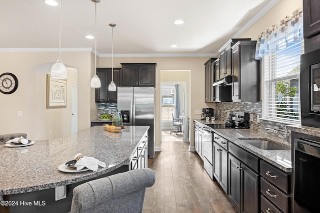 4104 Passerine Ave, Wilmington, NC 28412 - kitchen featuring a sink, a breakfast bar area, stainless steel appliances, decorative backsplash, and under cabinet range hood