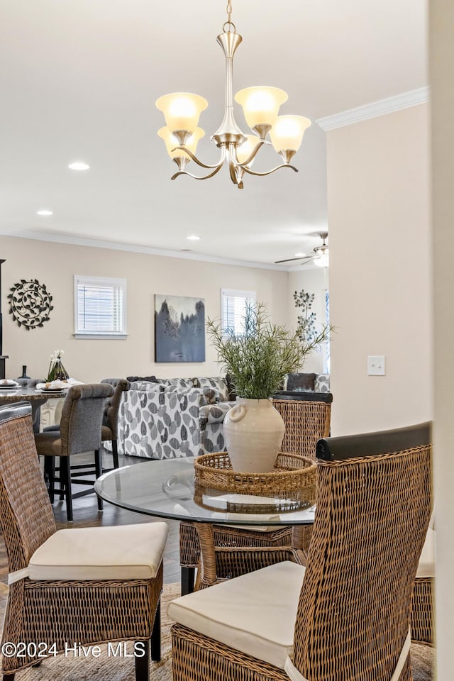 interior space featuring breakfast area, ornamental molding, wood finished floors, ceiling fan with notable chandelier, and recessed lighting