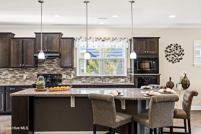 4104 Passerine Ave, Wilmington, NC 28412 - kitchen featuring dark brown cabinets, a sink, a center island, visible vents, and black appliances