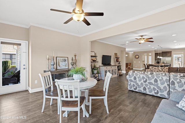 dining room featuring ornamental molding, dark wood finished floors, baseboards, and ceiling fan