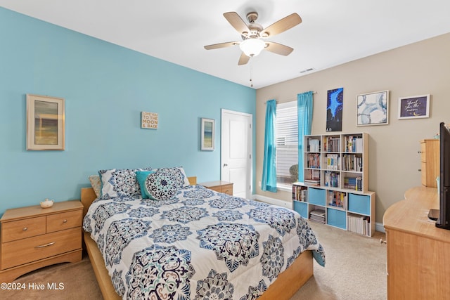 carpeted bedroom featuring ceiling fan, visible vents, and baseboards