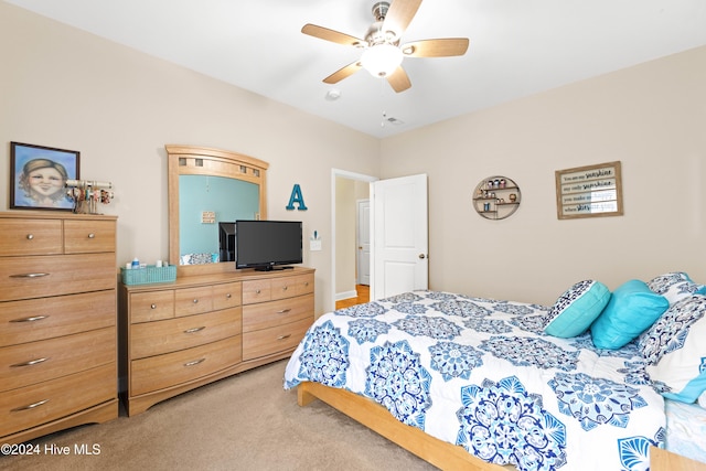 bedroom featuring light carpet and ceiling fan