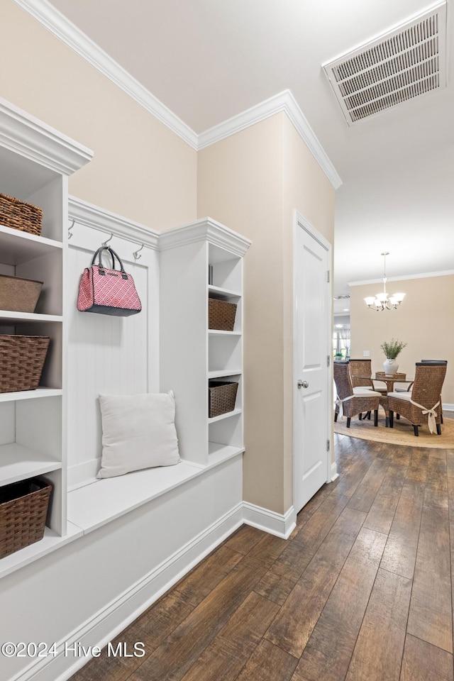 mudroom featuring visible vents, baseboards, wood-type flooring, ornamental molding, and a chandelier