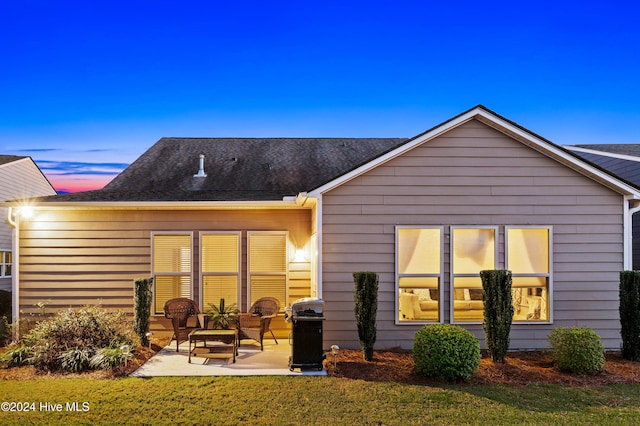 4104 Passerine Ave, Wilmington, NC 28412 - back of house at dusk featuring a patio and a yard