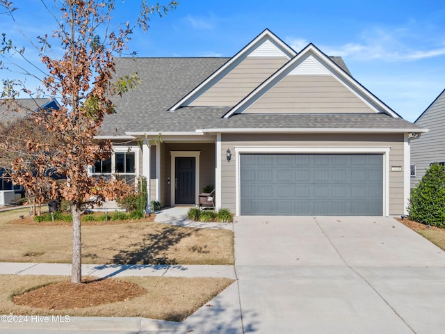 4104 Passerine Ave, Wilmington, NC 28412 - view of front facade with a shingled roof, an attached garage, and concrete driveway
