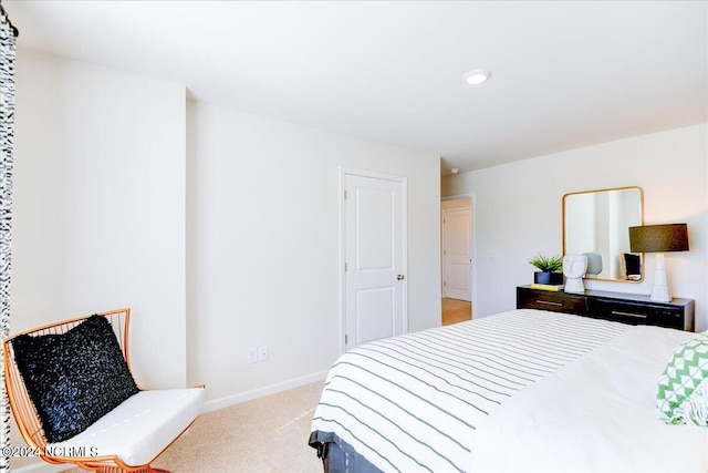 bedroom featuring light carpet